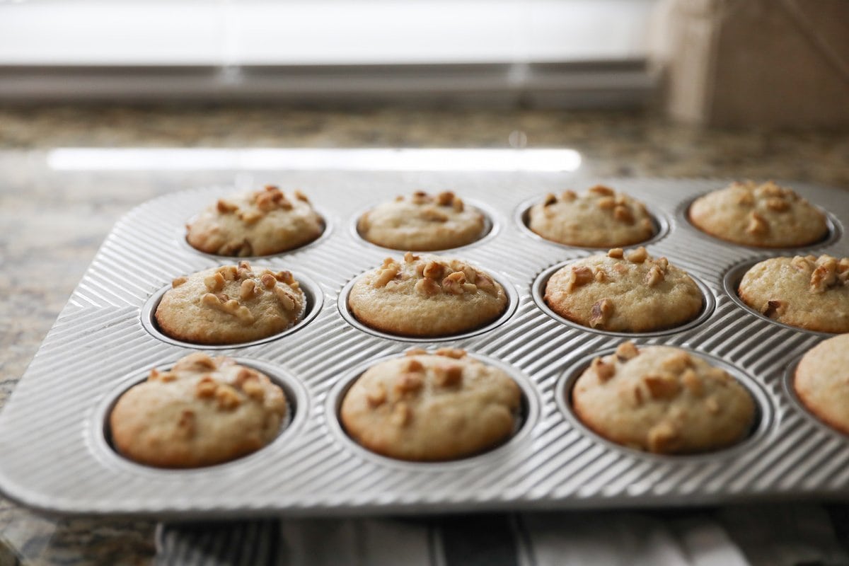 baked banana nut muffins in a muffin tin