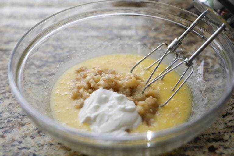 adding sour cream and mashed bananas to batter