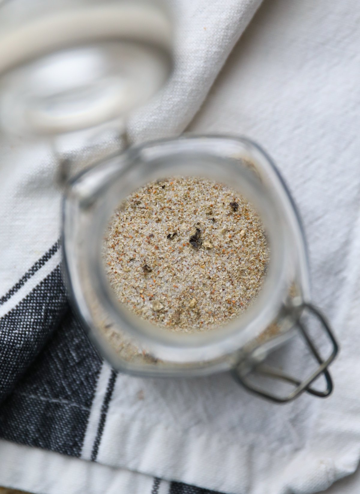 top down view of chicken seasoning in a glass jar