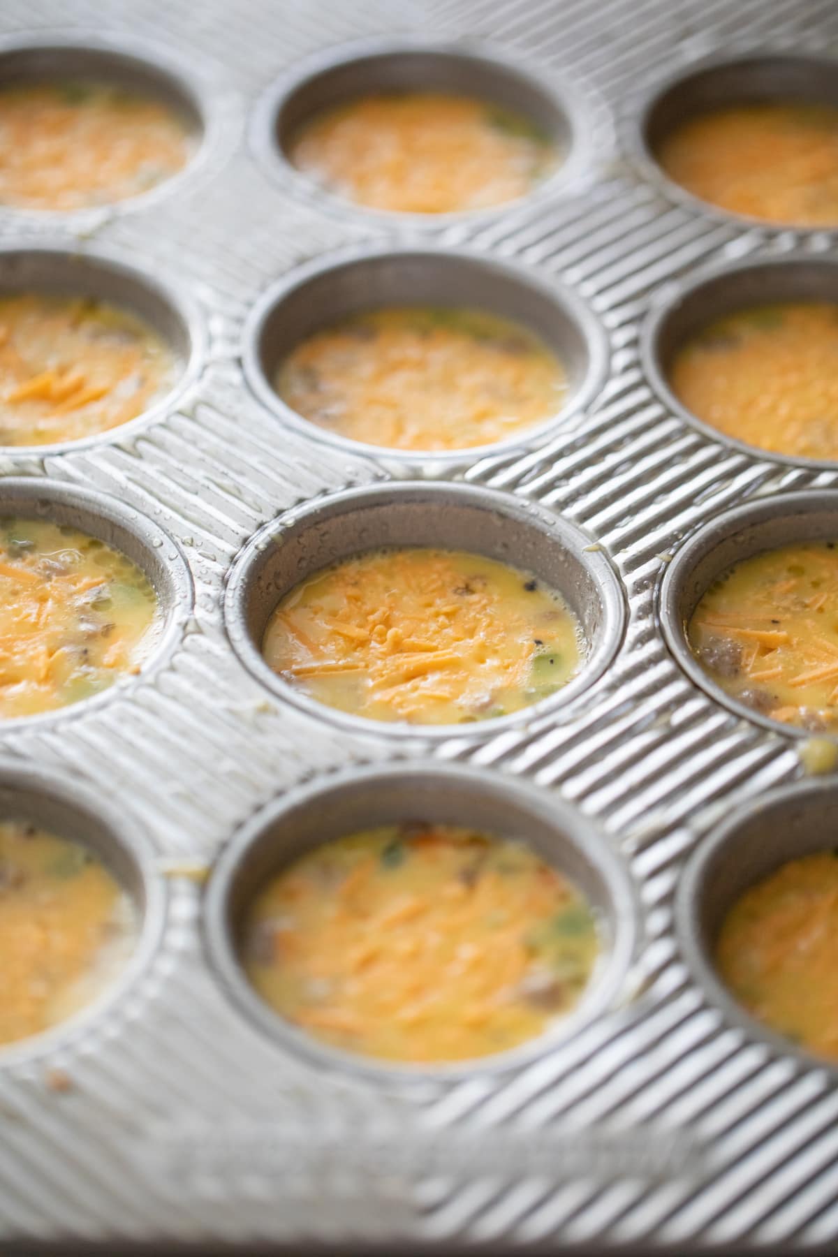 unbaked egg muffins in muffin tins