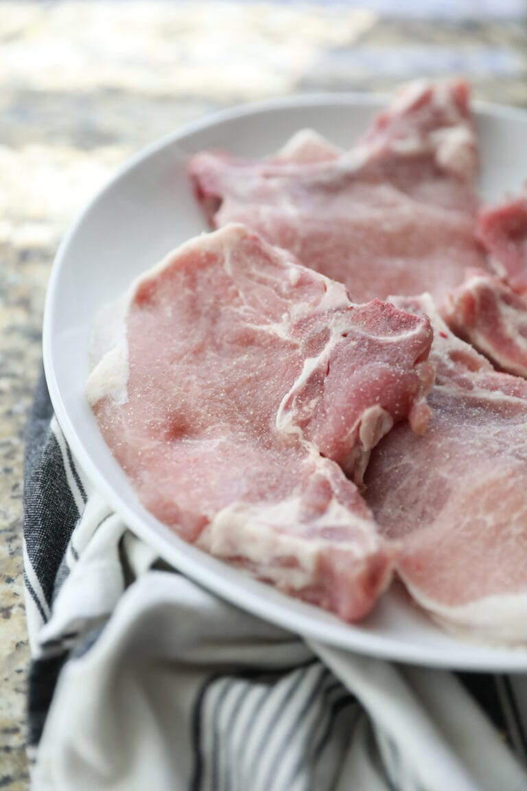 raw bone in pork chops on plate