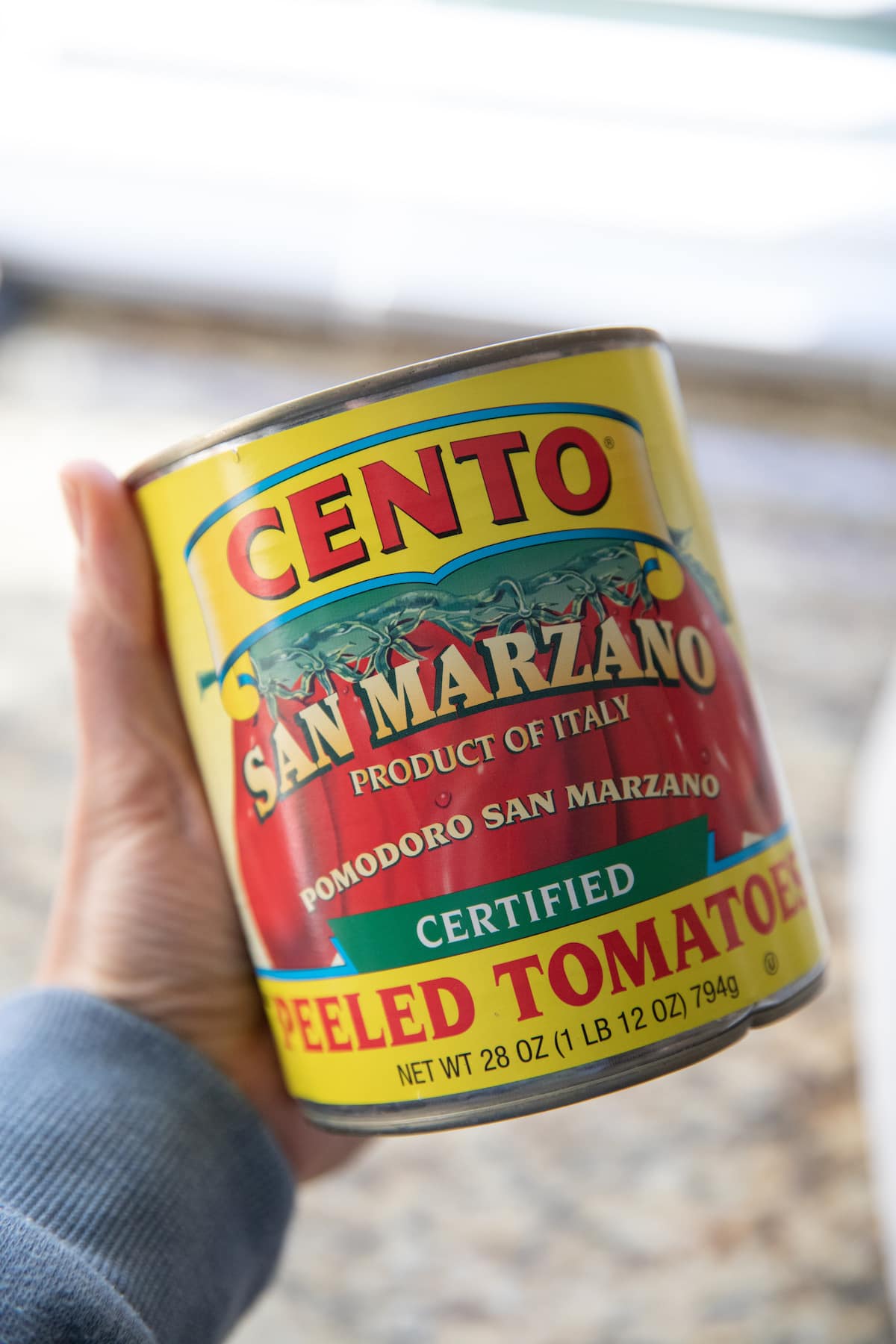 hand holding can of san marzano tomatoes