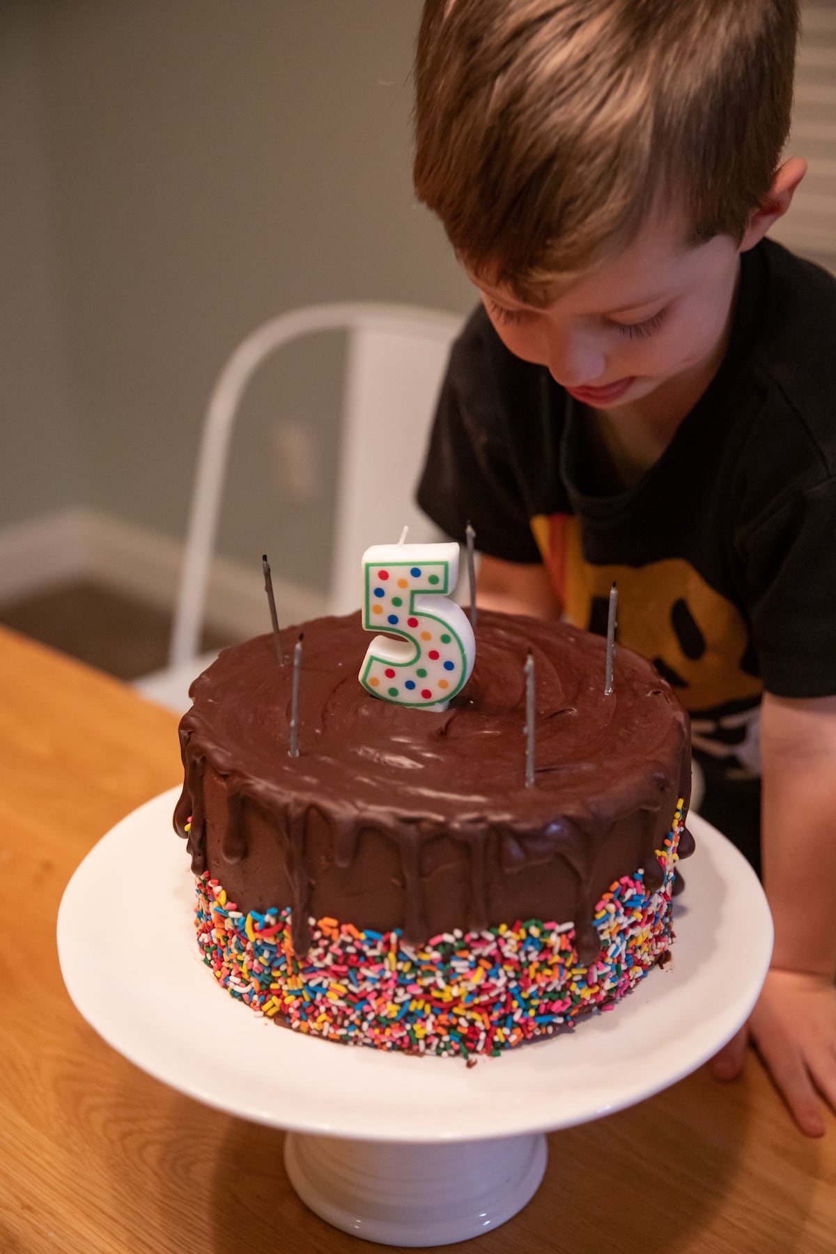 boy looking at birthday cake