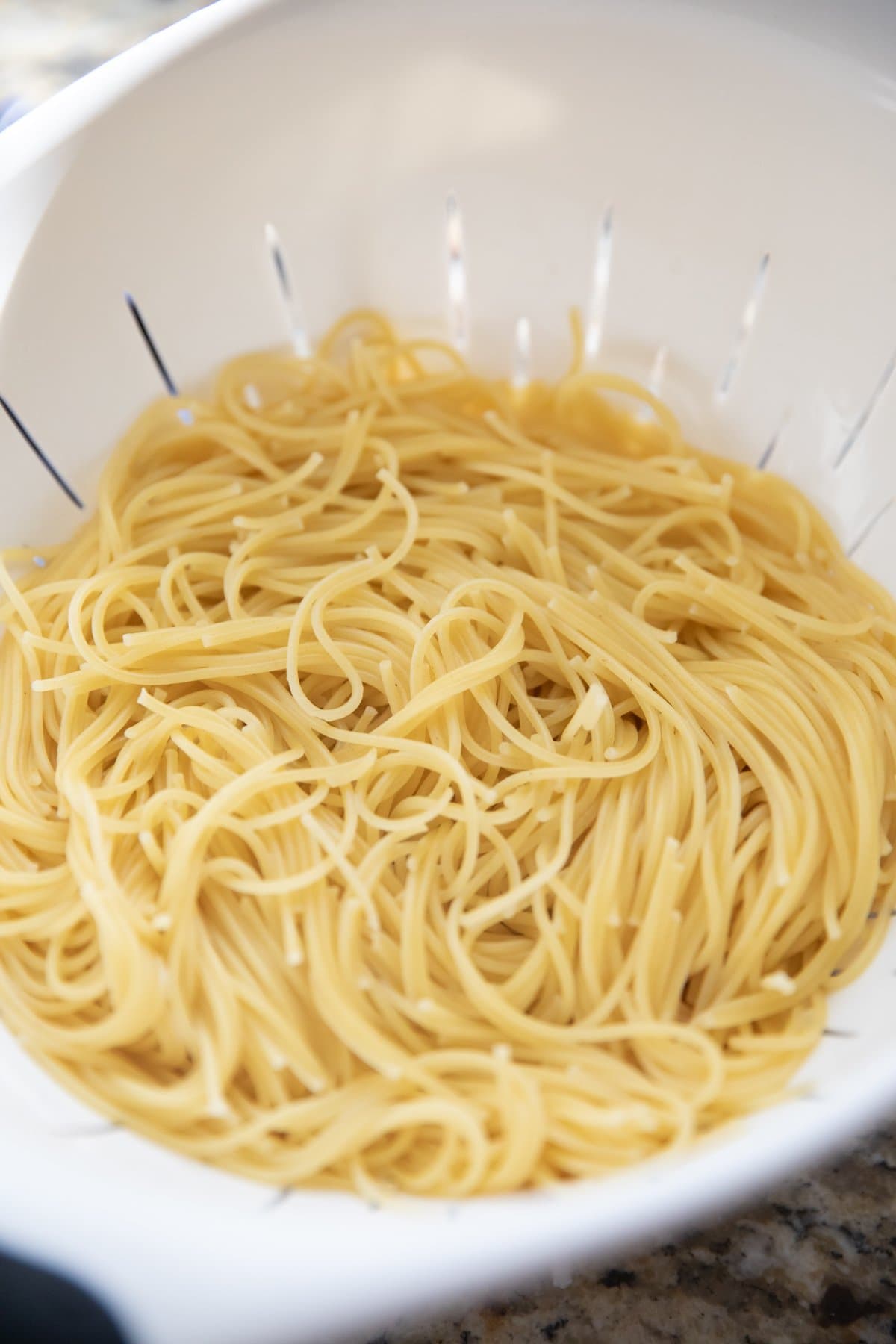 thin spaghetti in colander