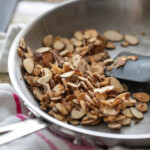 stirring the almonds with sugar in pan
