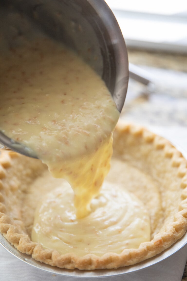 pouring filling into pie crust