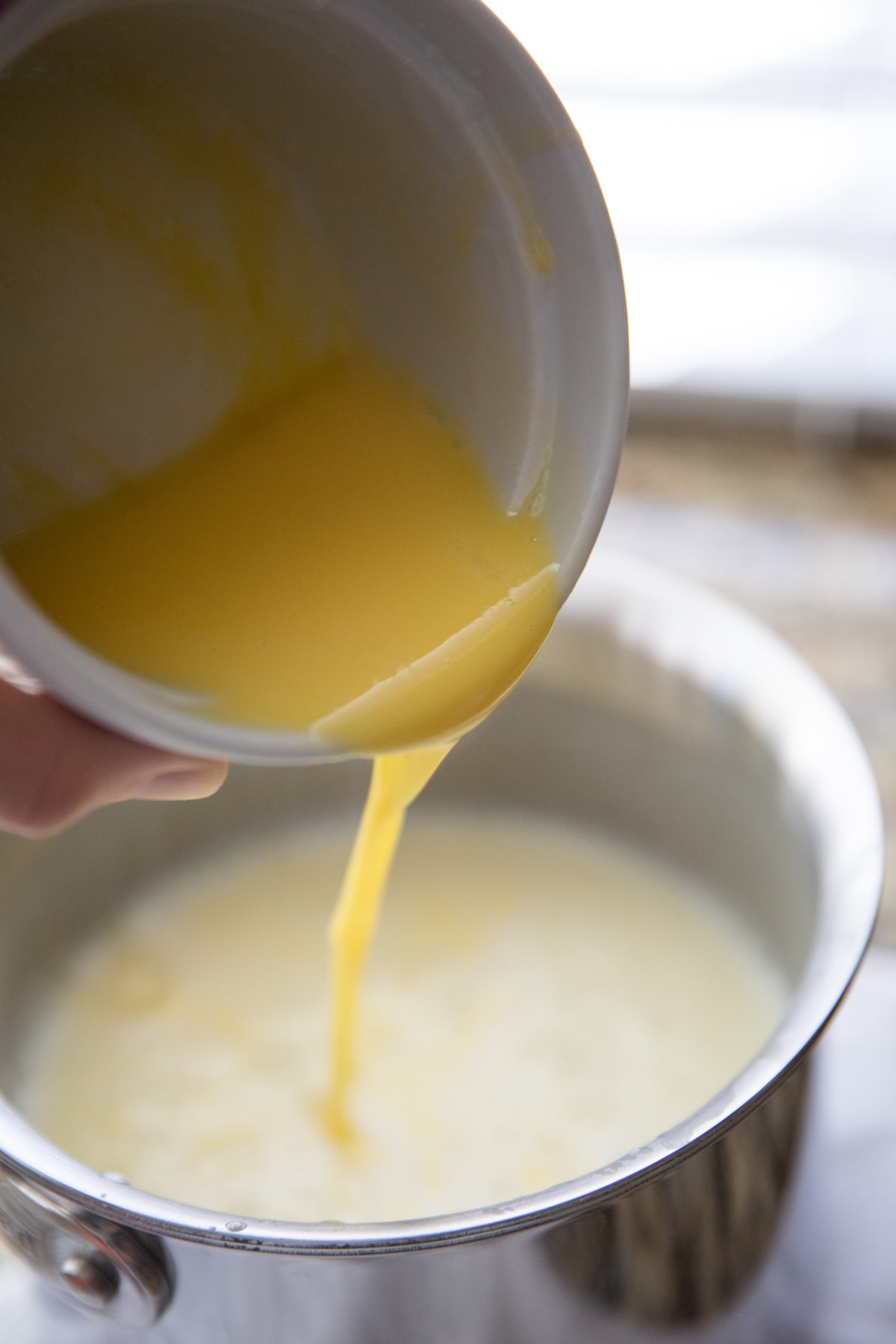 pouring egg yolks back into filling