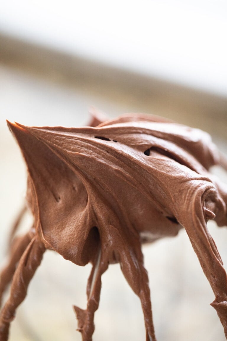whipped chocolate ganache frosting on whisk