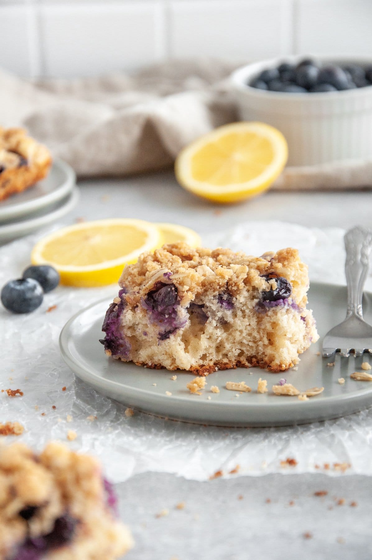slice of lemon blueberry coffee cake on a plate with a fork
