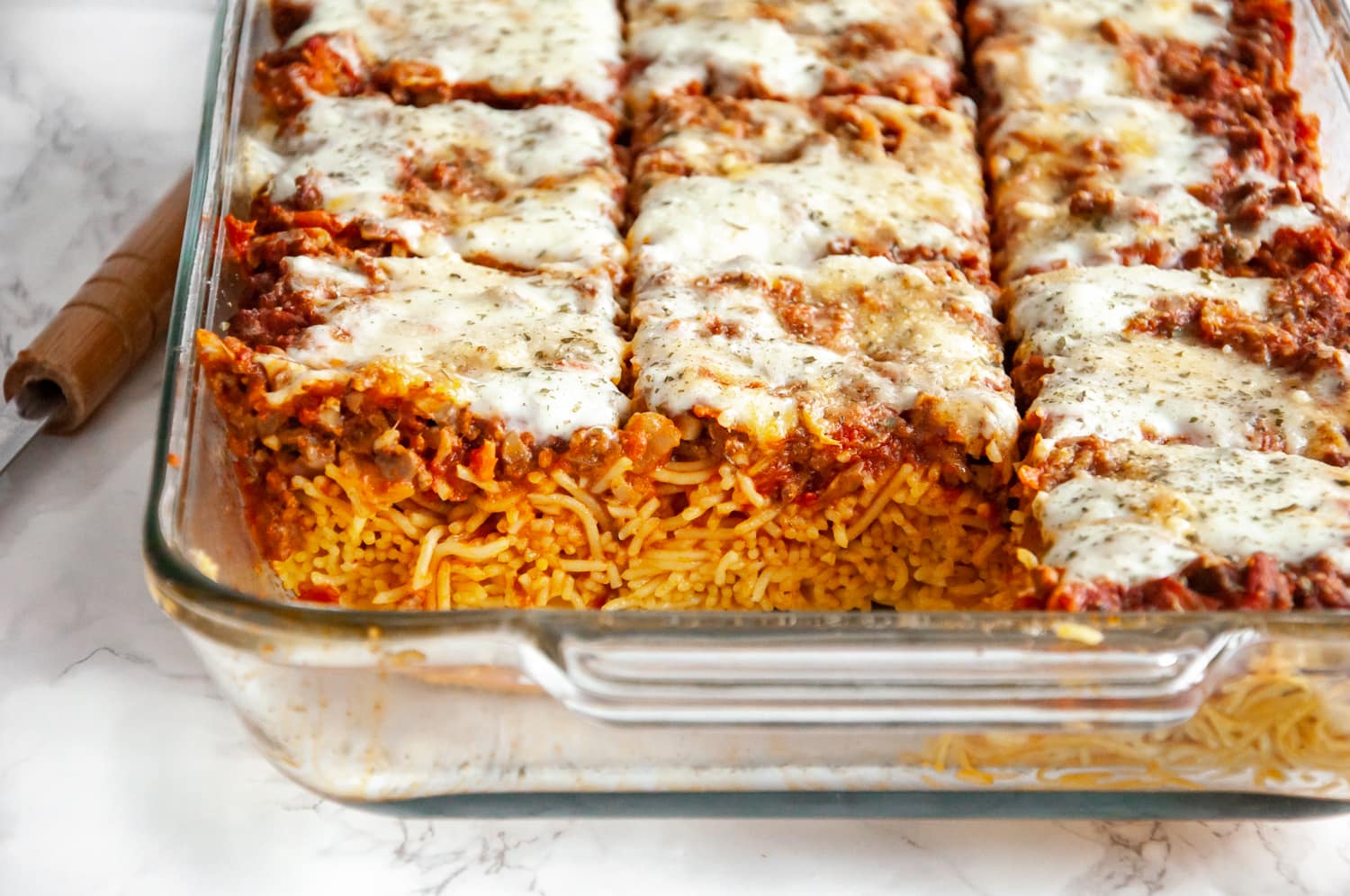 sliced baked spaghetti in a glass baking dish