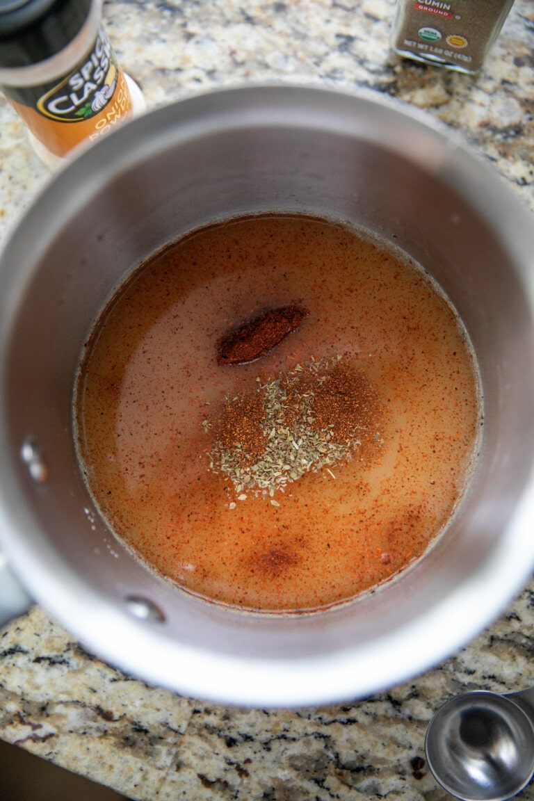 chicken broth and spices in pot