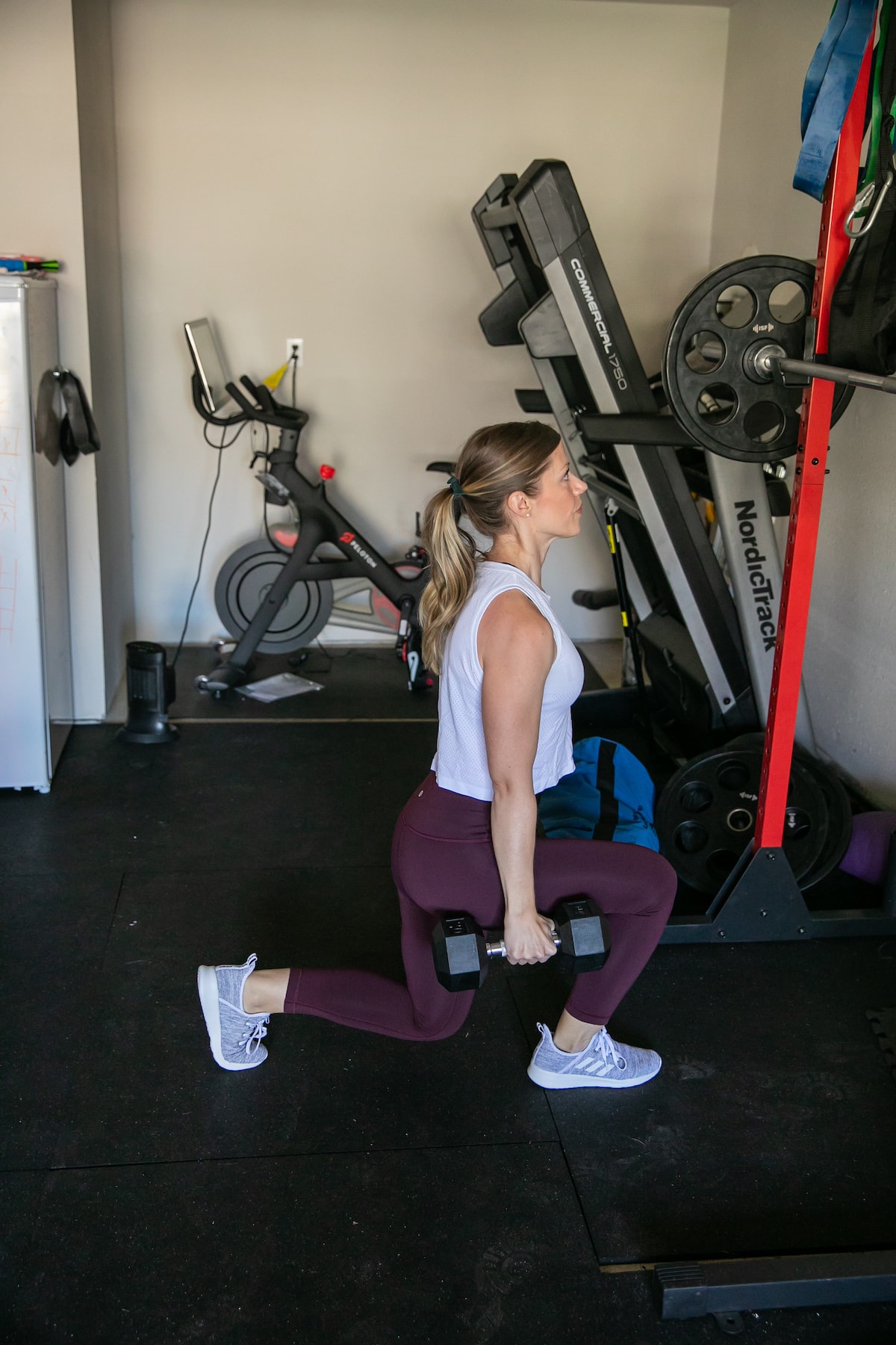 woman lunging with weights