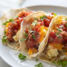 breakfast tacos on a white plate