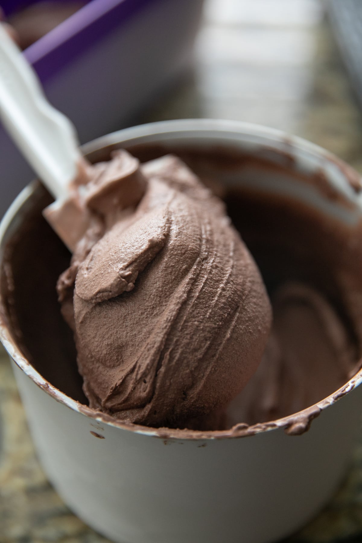 scooping chocolate ice cream out of ice cream maker