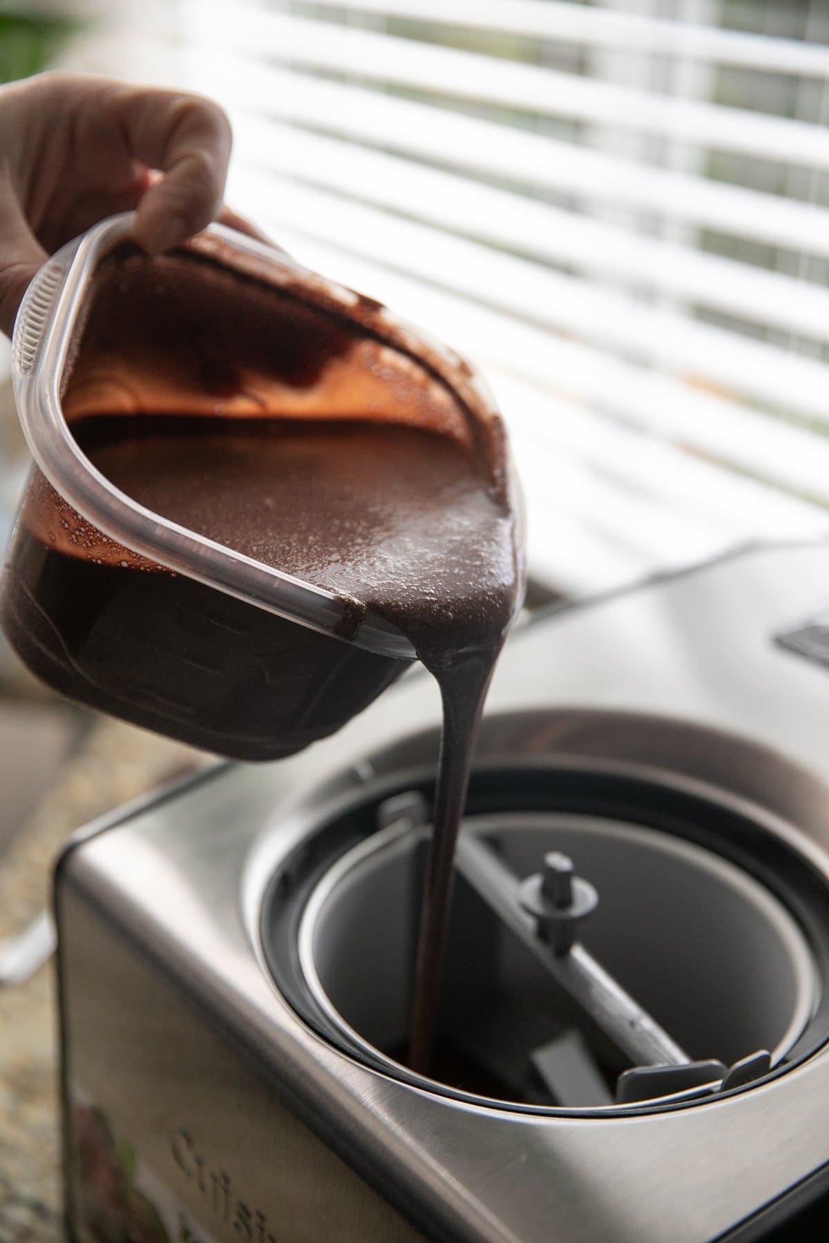 pouring chocolate base into an ice cream machine