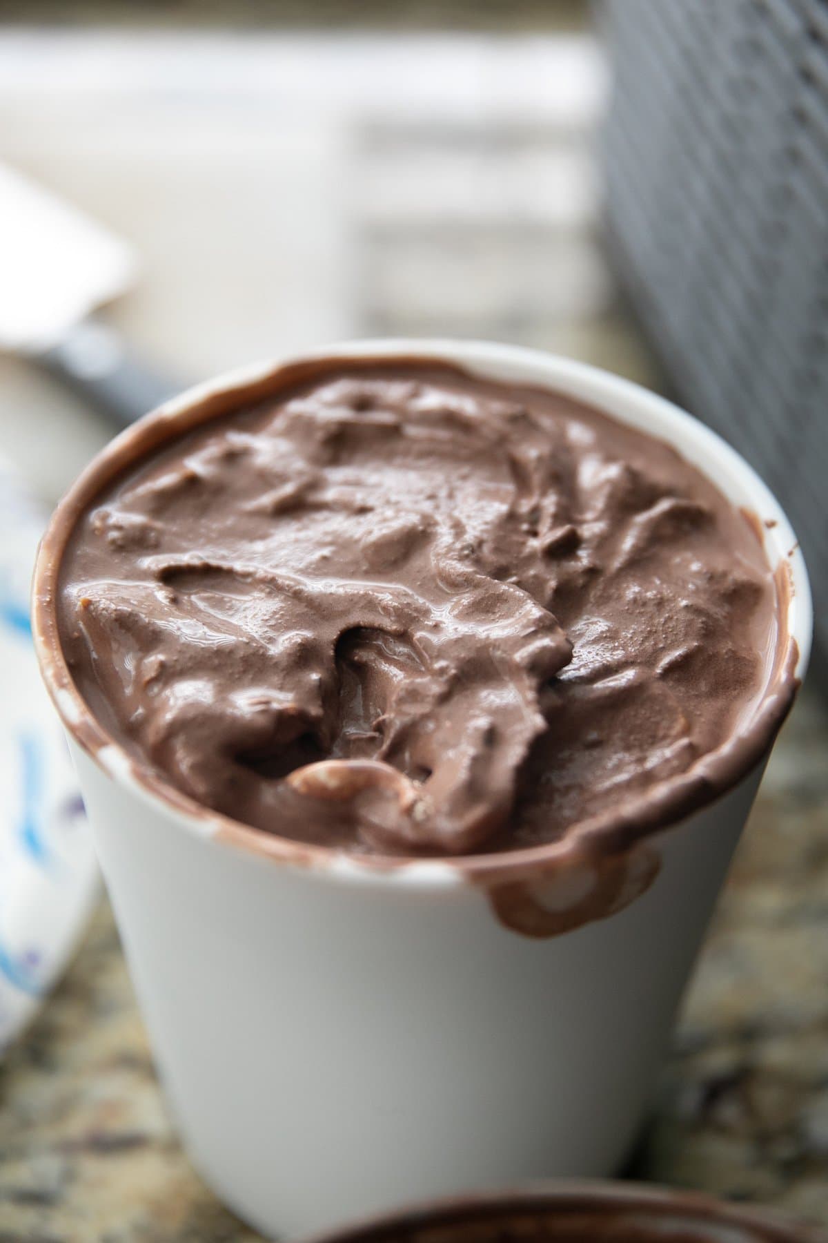 churned chocolate ice cream in a white bucket