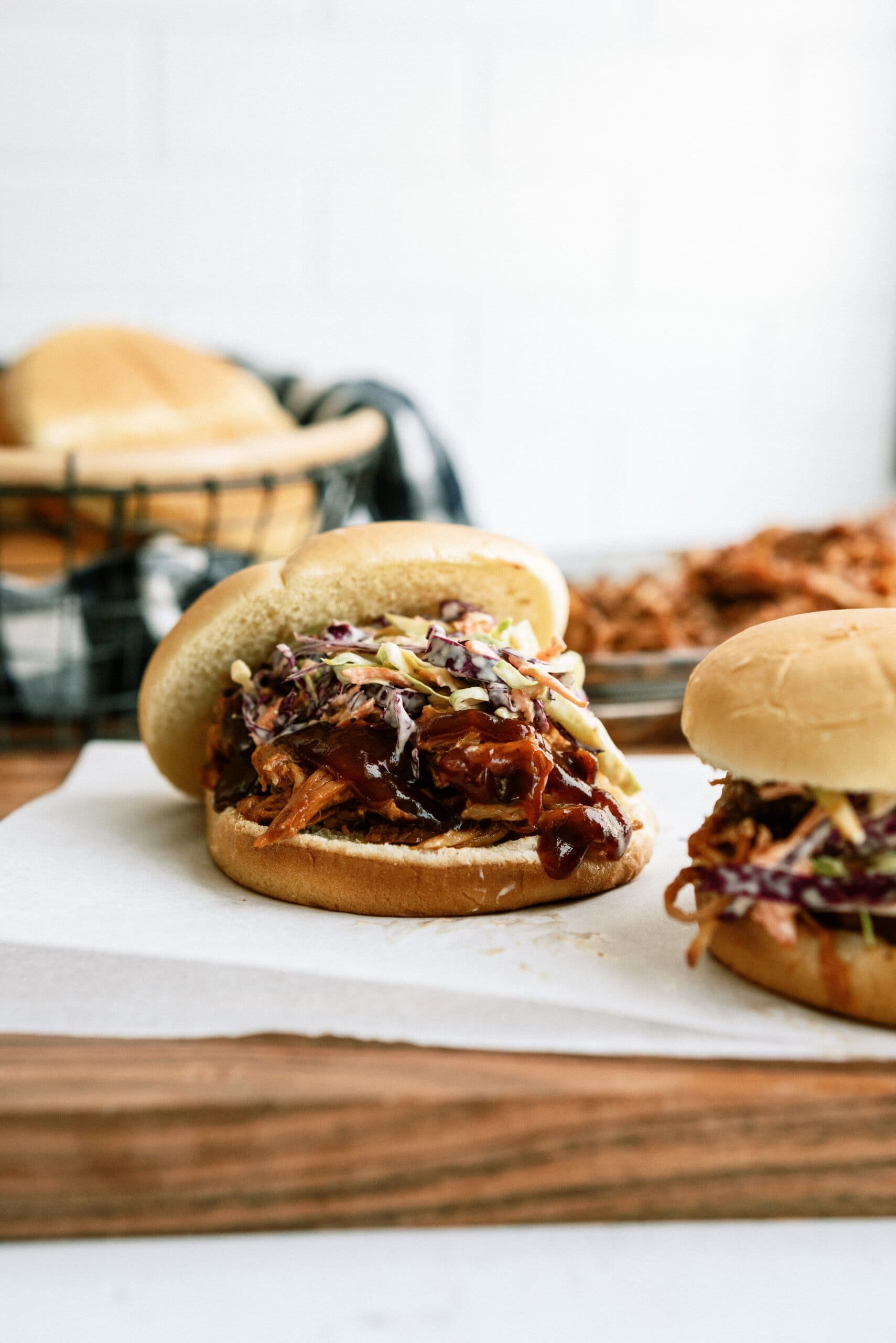 topping pulled pork sandwiches with coleslaw