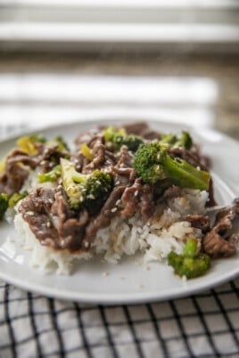 beef and broccoli over rice on plate