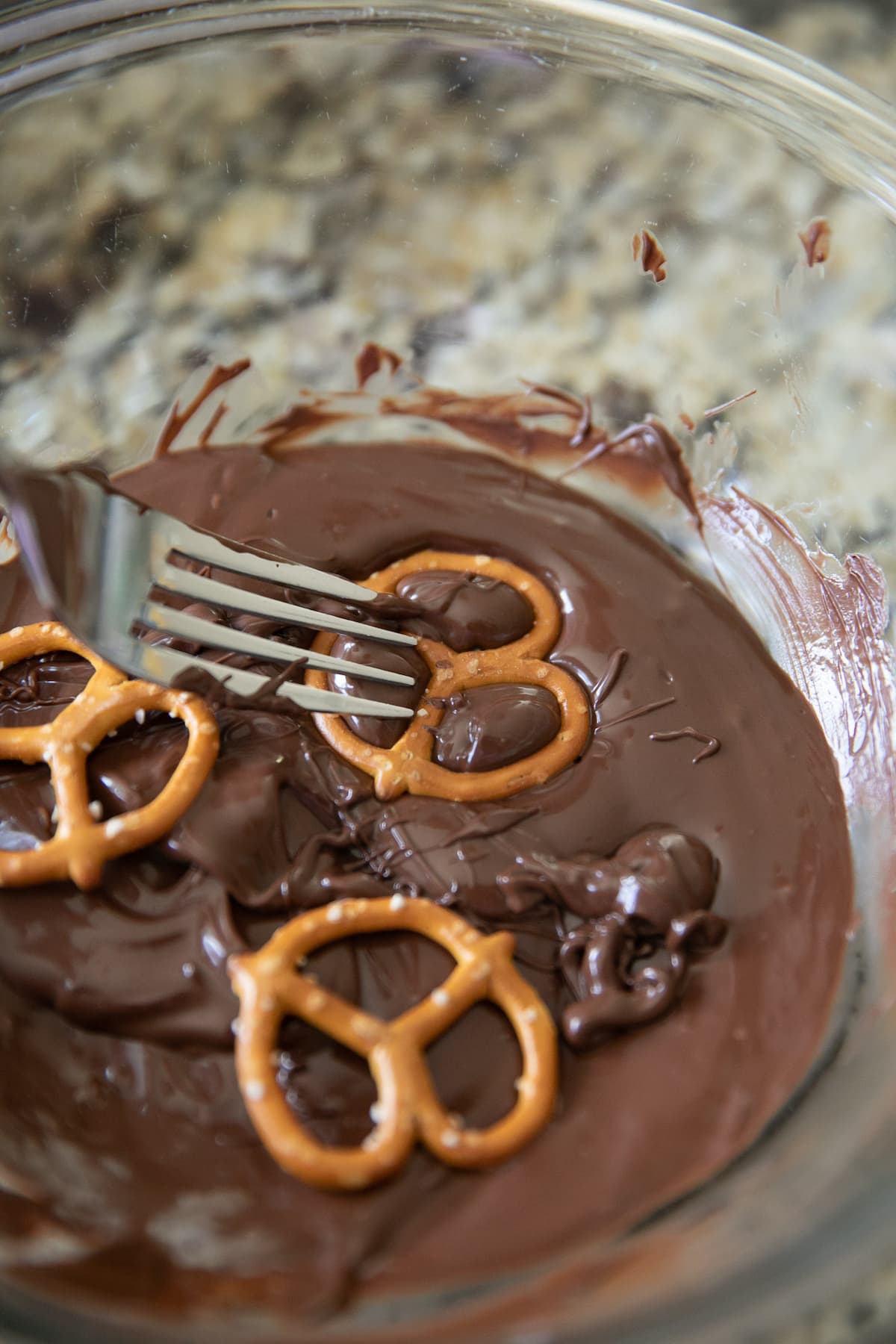 dipping pretzels into melted chocolate