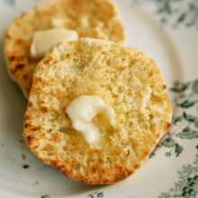 two halves of an english muffin with butter on them