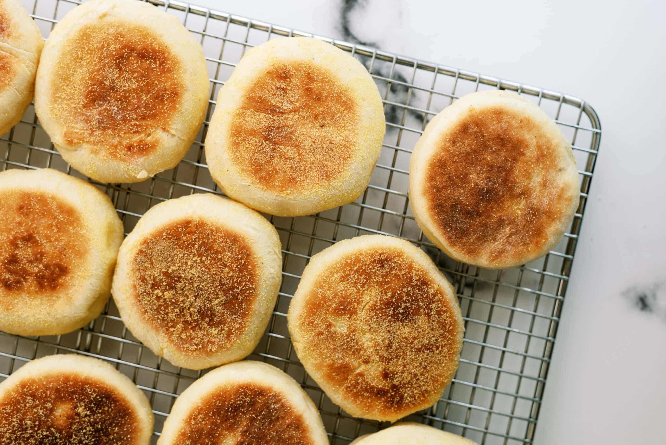 top down view of english muffins on a cooling wrack