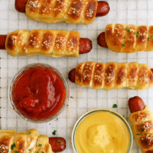 pretzel dogs on a cooling wrack with ketchup and mustard