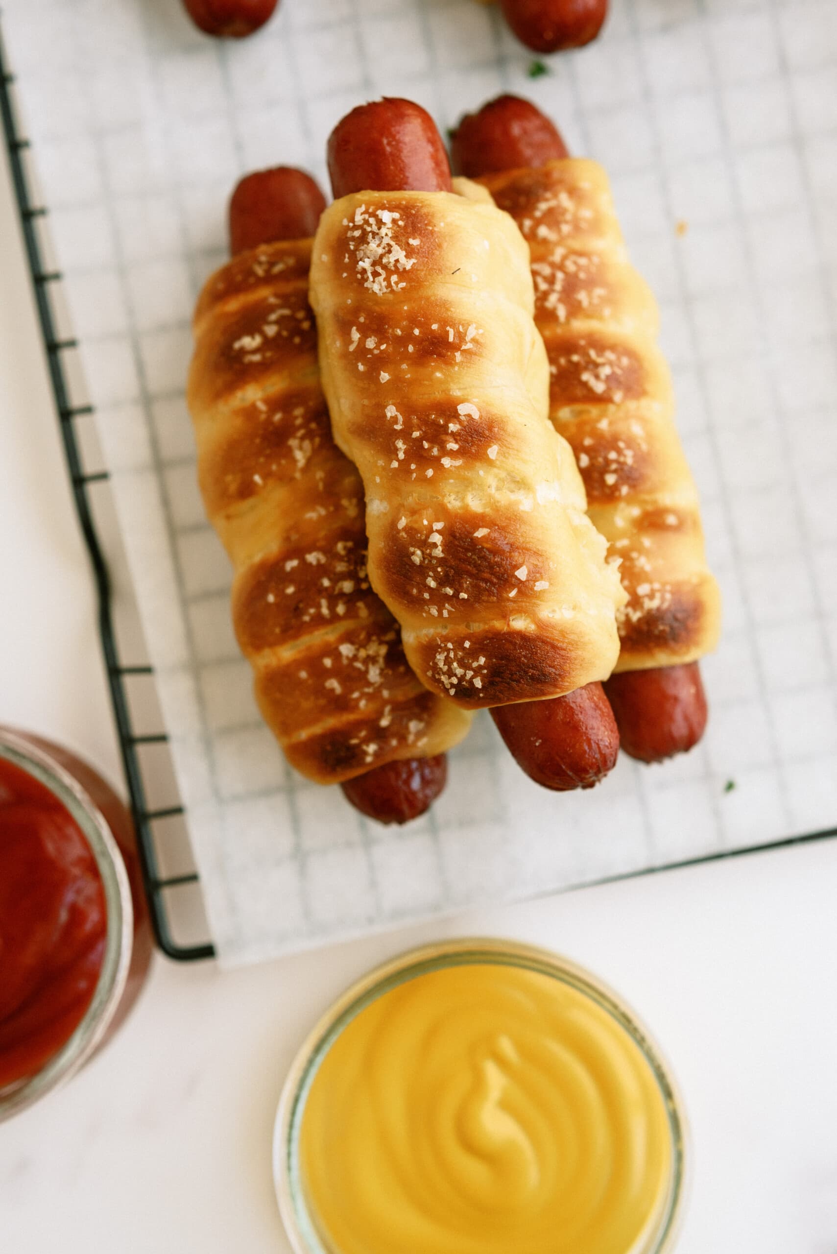 top down view of three pretzel dogs stacked on top of each other