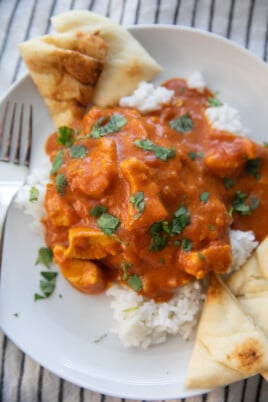 butter chicken over rice with pita