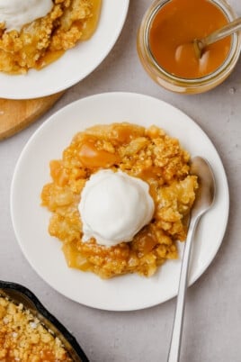 top down view of salted caramel apple crumble with a scoop of vanilla ice cream