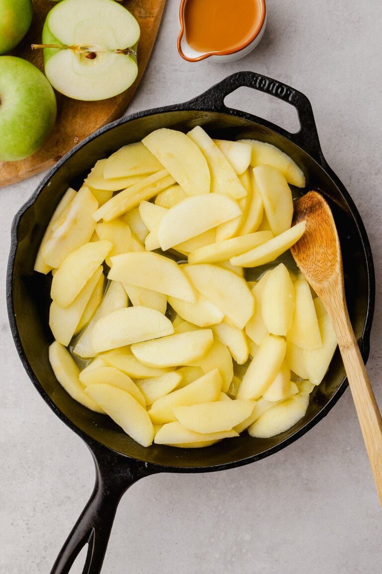peeled and sliced apples in a cast iron skillet