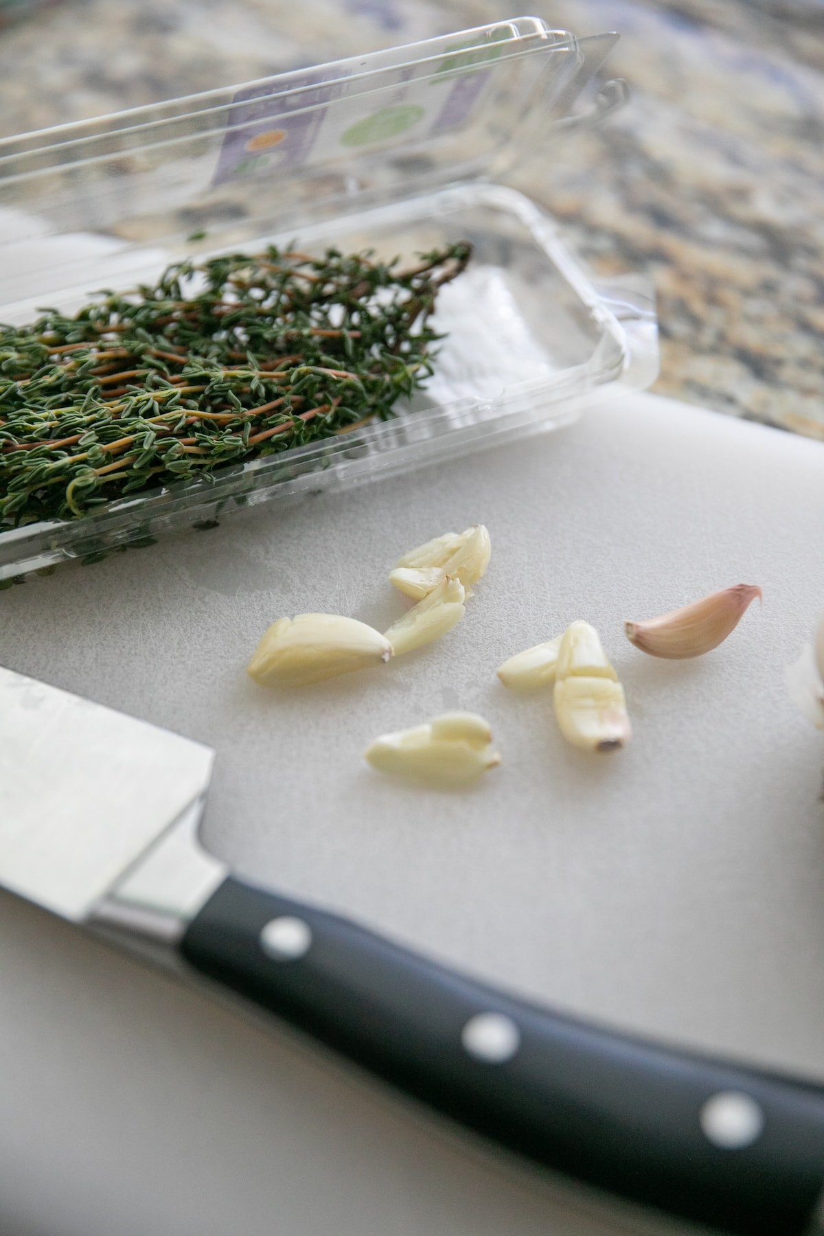 garlic and herbs on cutting board