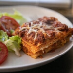 lasagna on plate with salad