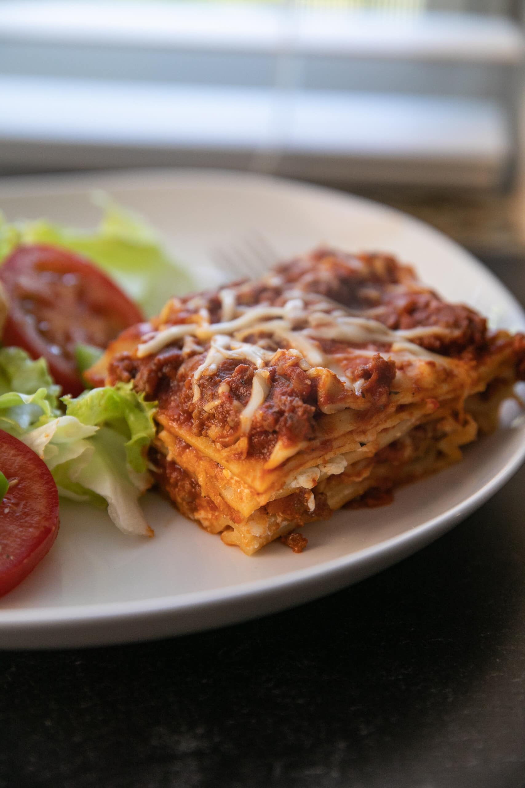lasagna on plate with salad