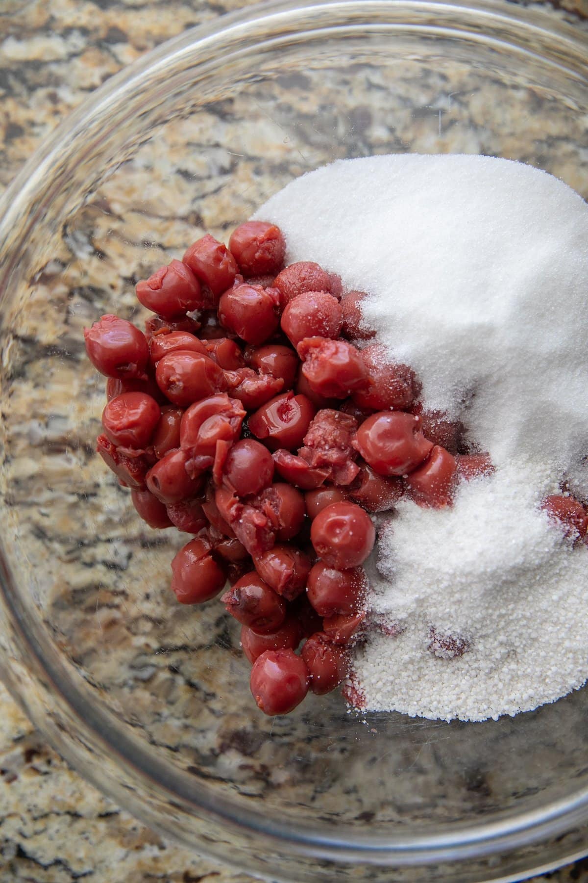 cherries, sugar, tapioca and other ingredients in a glass bowl
