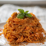 chicken spaghetti with breadcrumbs on plate
