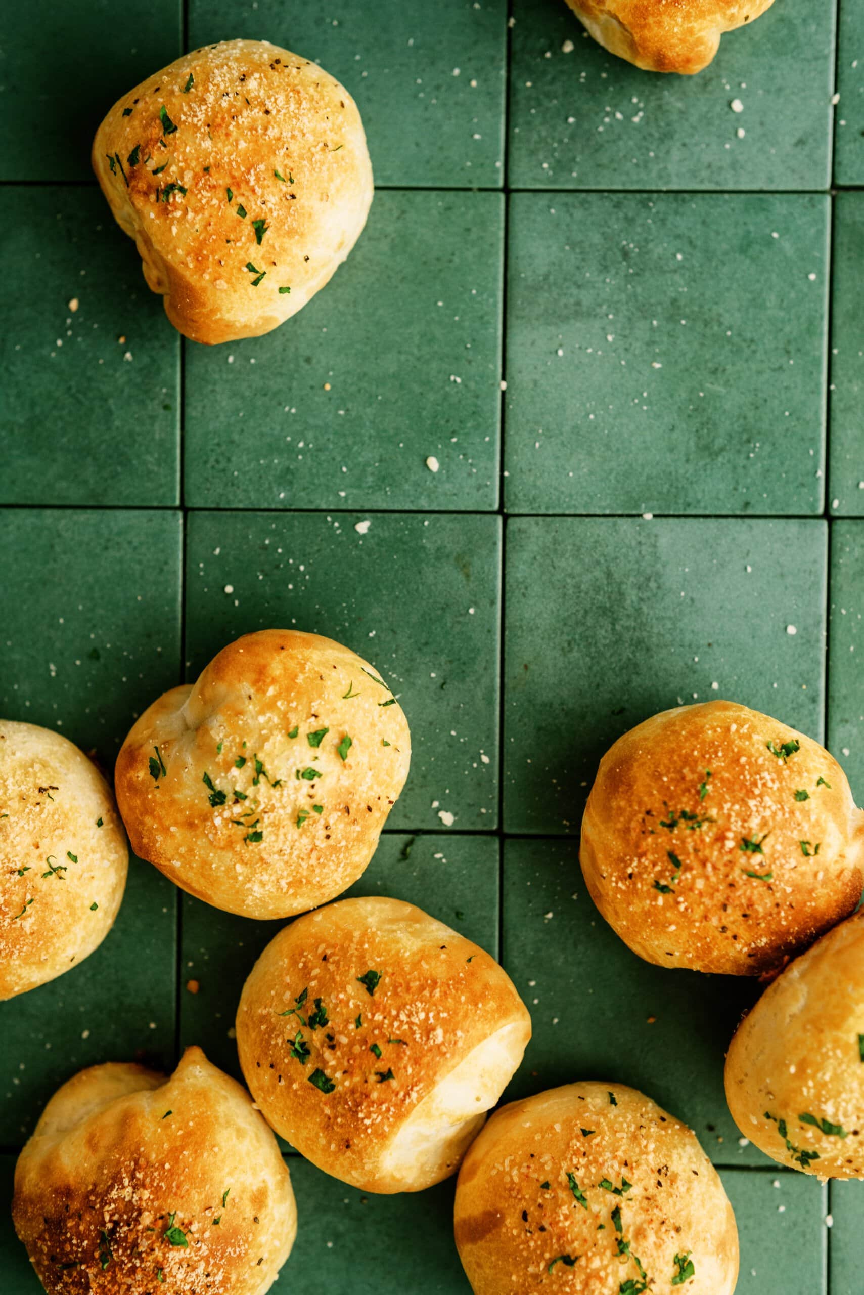 parmesan bread bites on a green counter