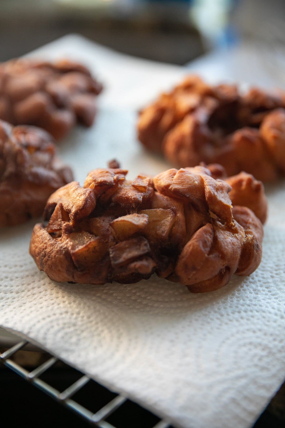 cooked apple fritters on paper towels