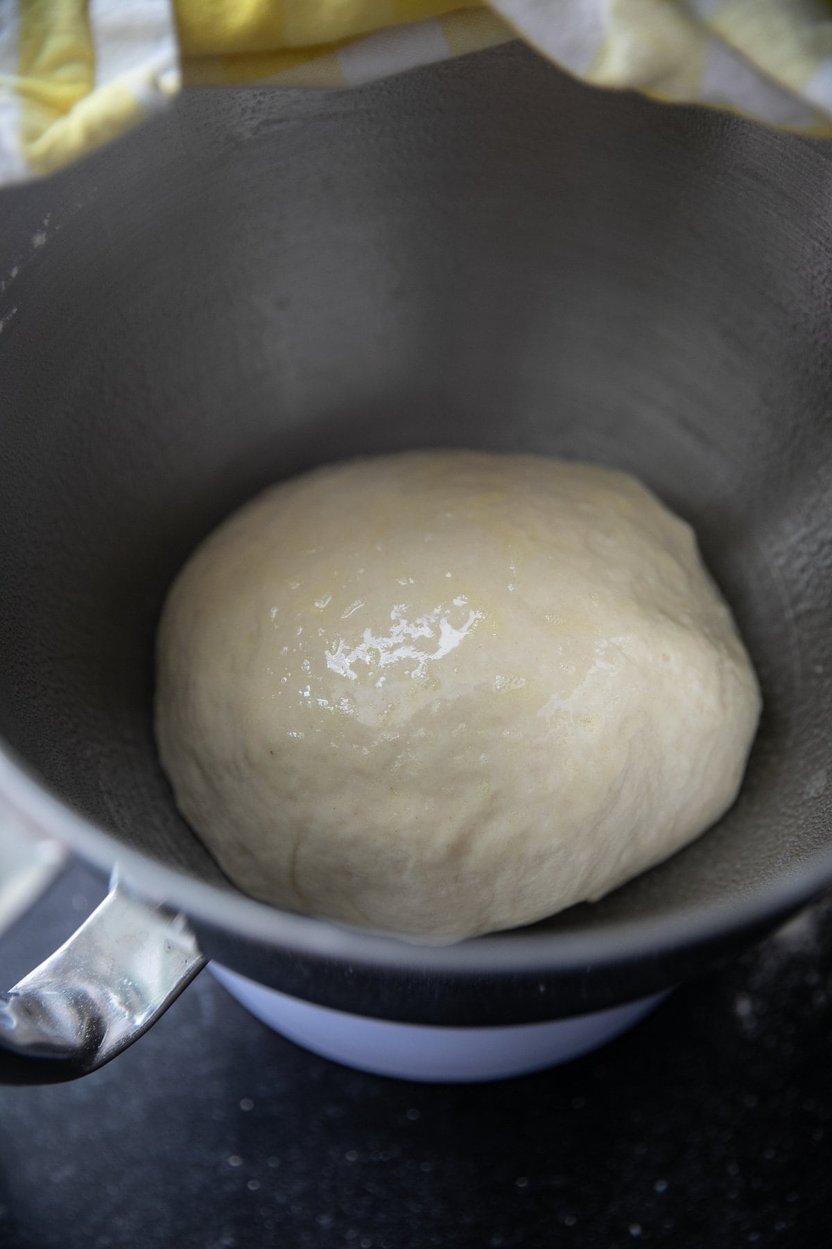 dough resting in a metal bowl