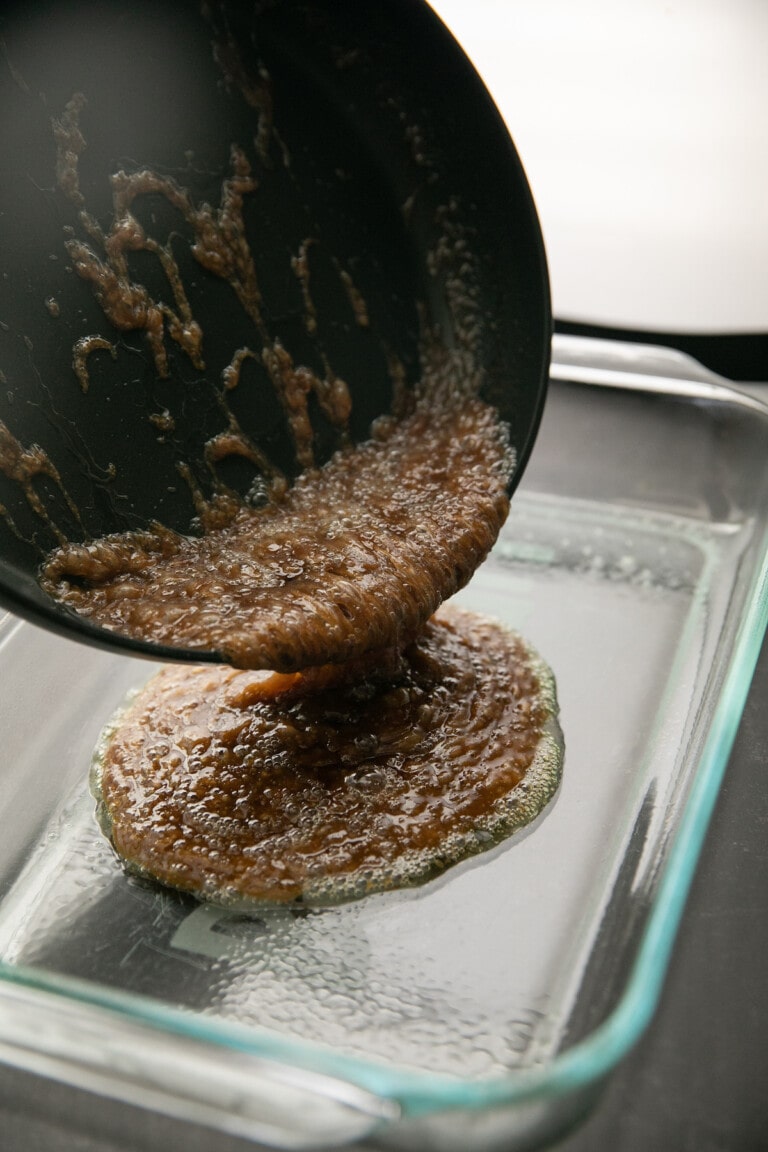 pouring brown sugar mixture into a glass baking dish