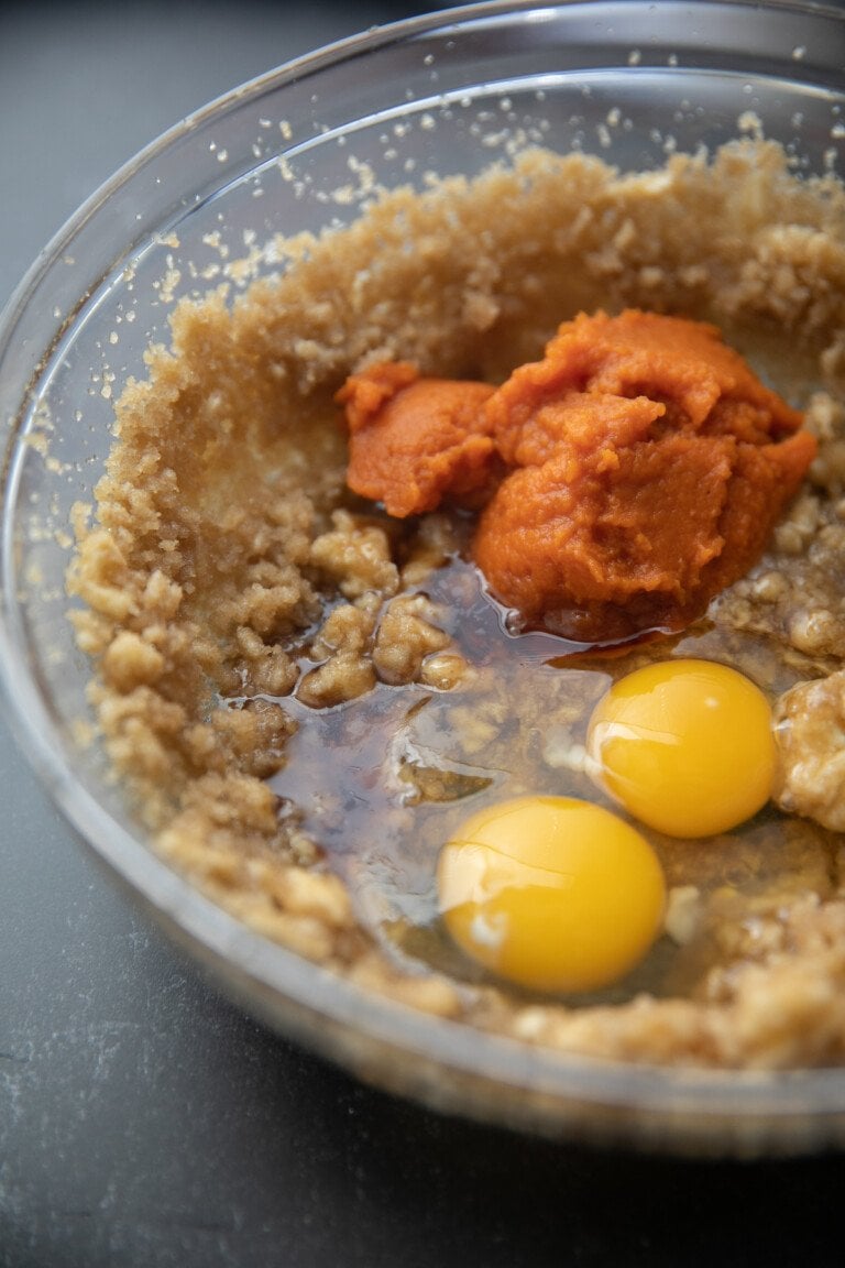 pumpkin puree, eggs and sugar mixture, unmixed, in a glass bowl