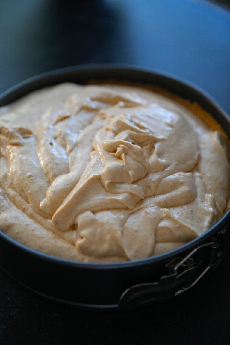 pumpkin cheesecake batter in a graham cracker crust all in a springform pan