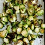 oven roasted brussel sprouts on a parchment paper lined baking sheet
