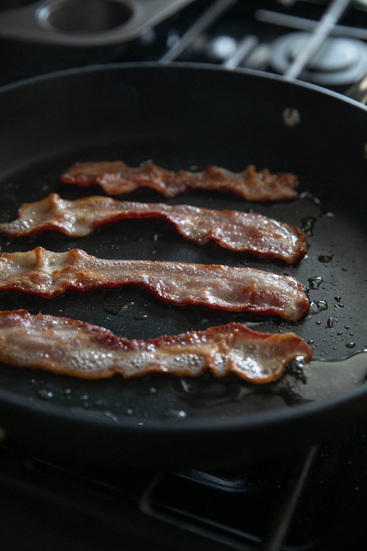 cooking bacon in a pan