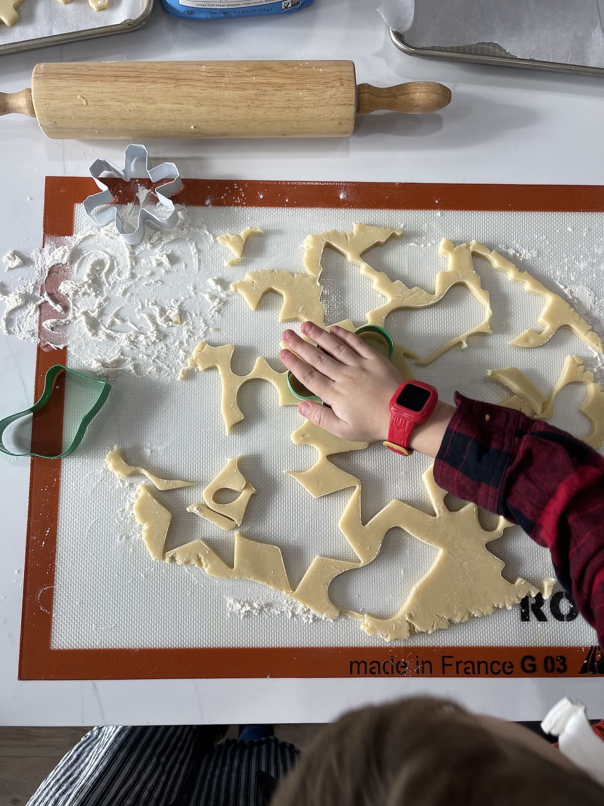 hand cutting out sugar cookies