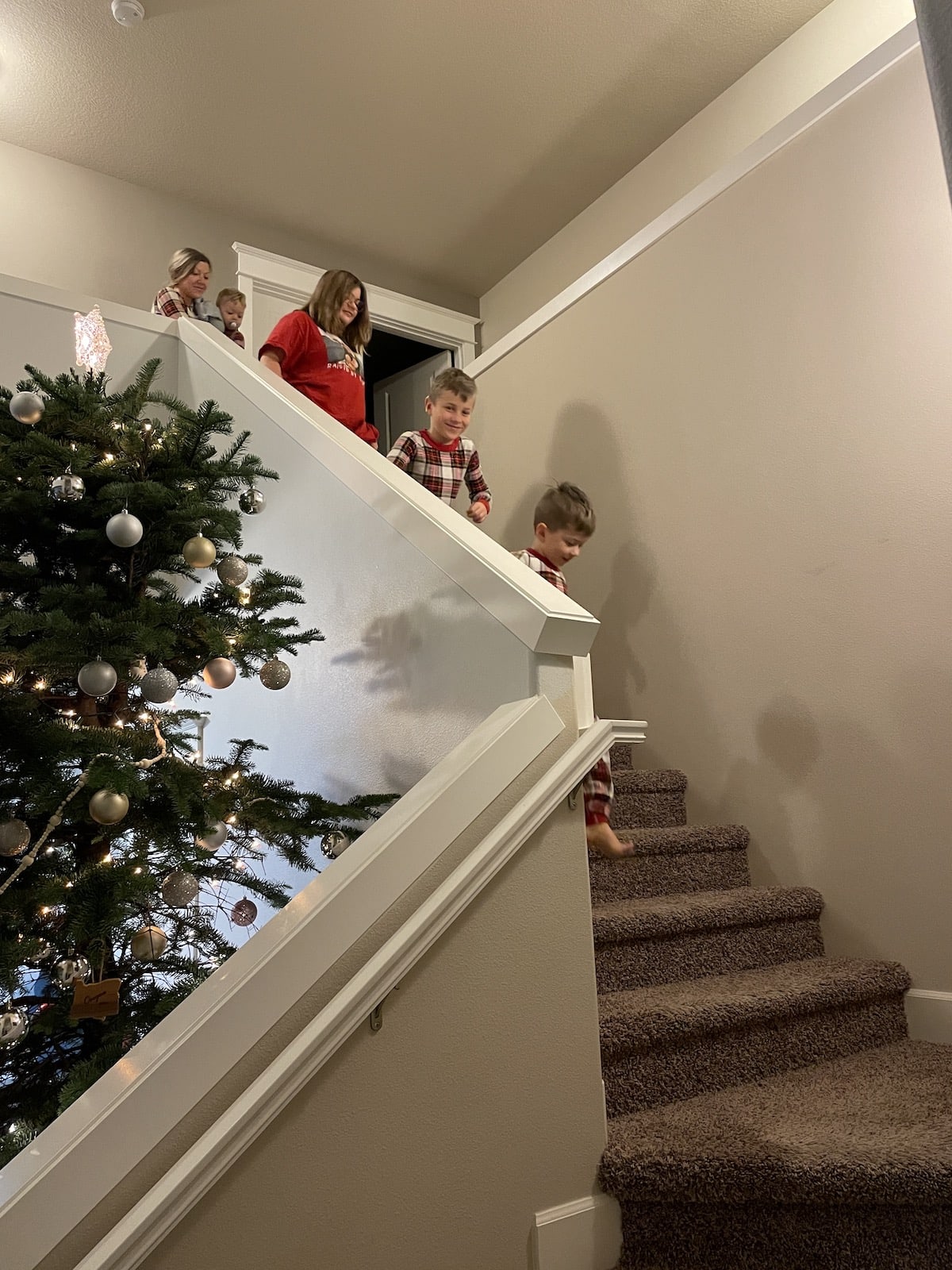 family walking down stairs christmas morning