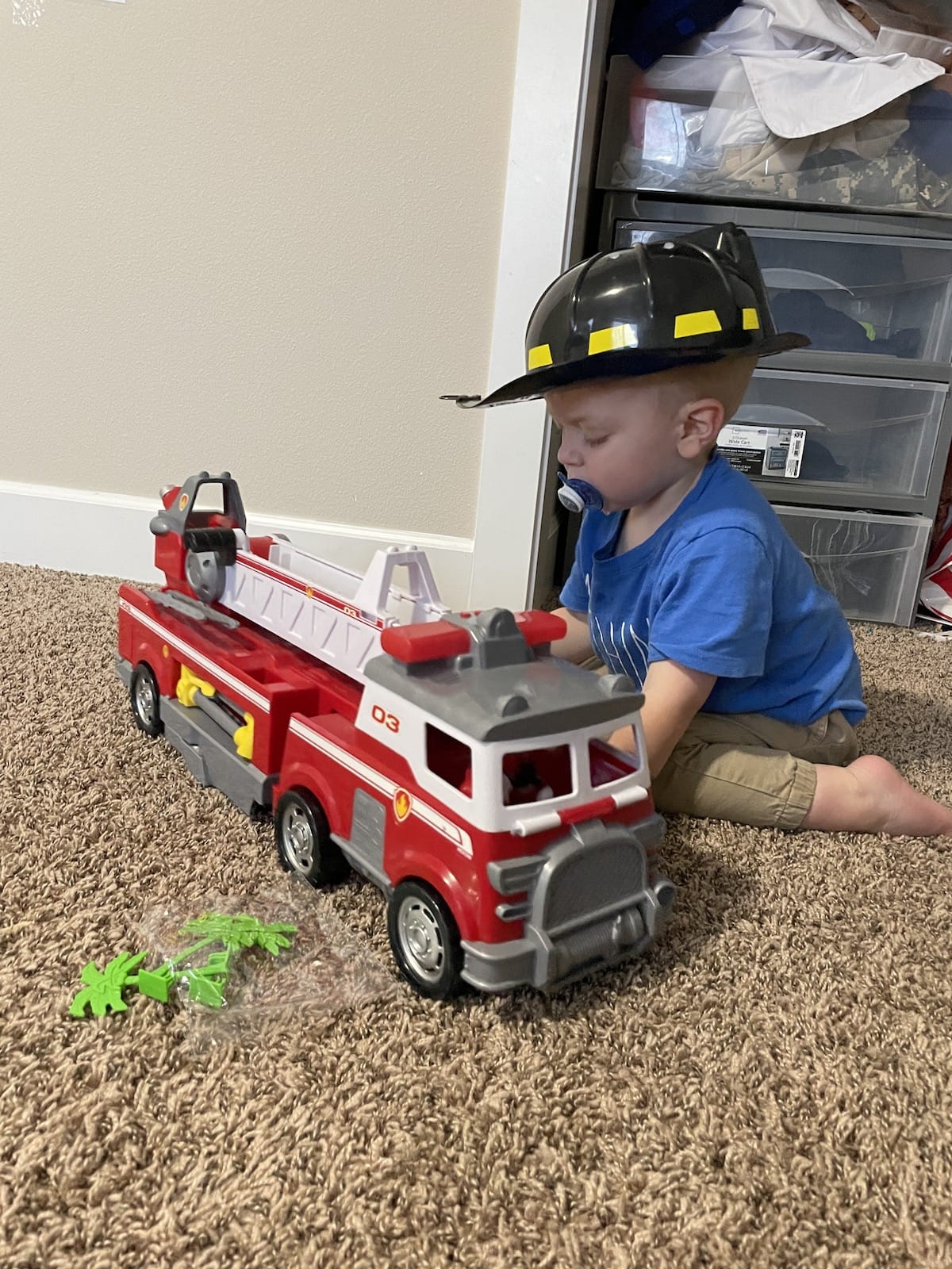 toddler playing with fire truck toy