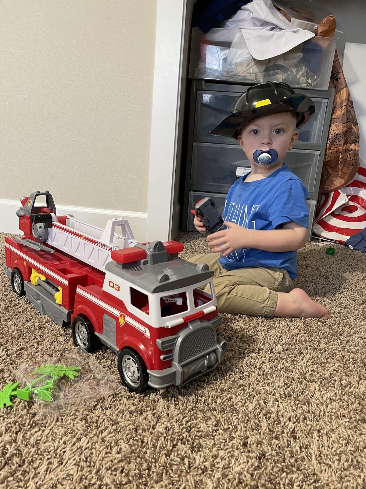 toddler playing with fire truck toy