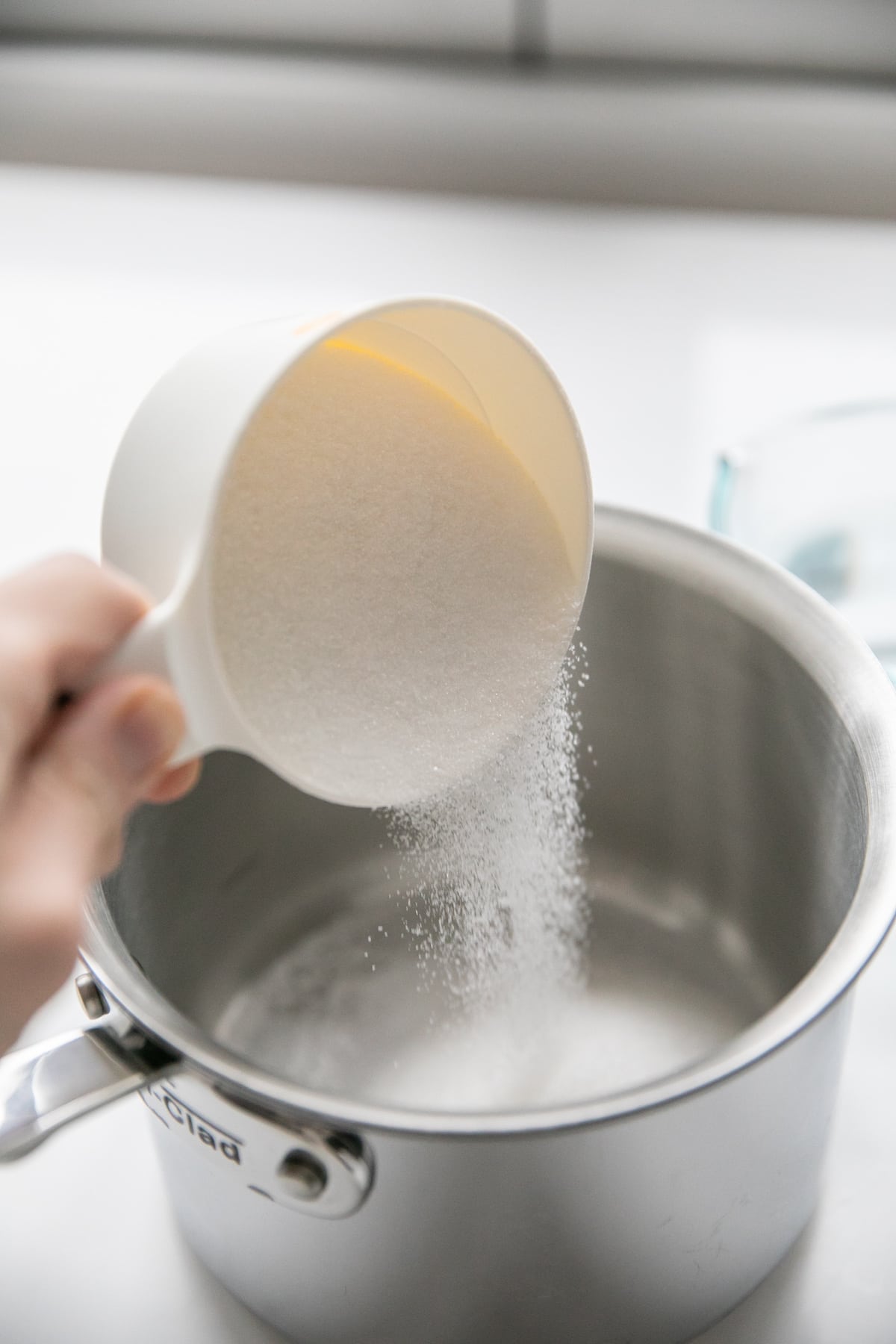 pouring sugar into pot