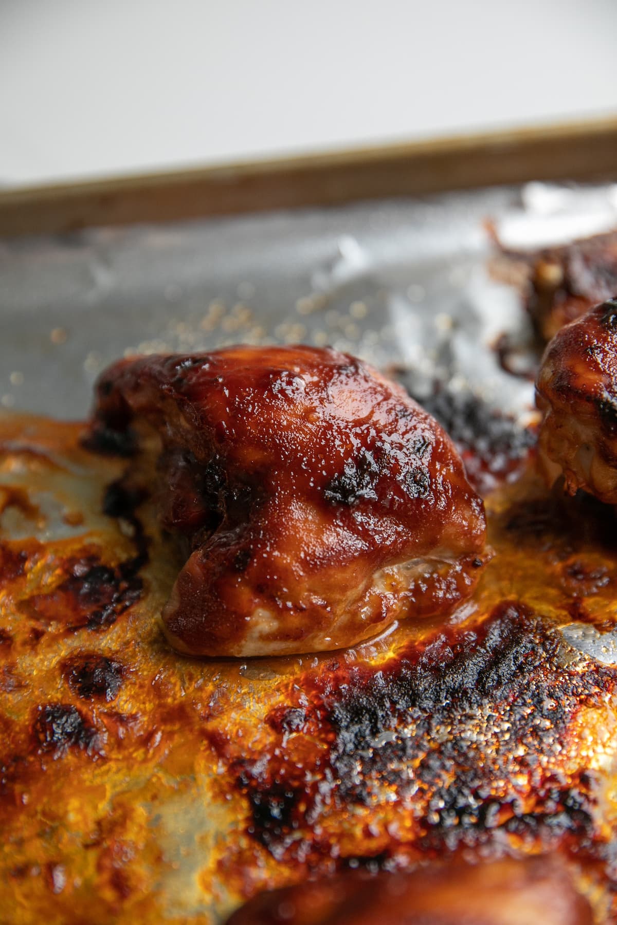 oven bbq chicken on baking sheet with sauce
