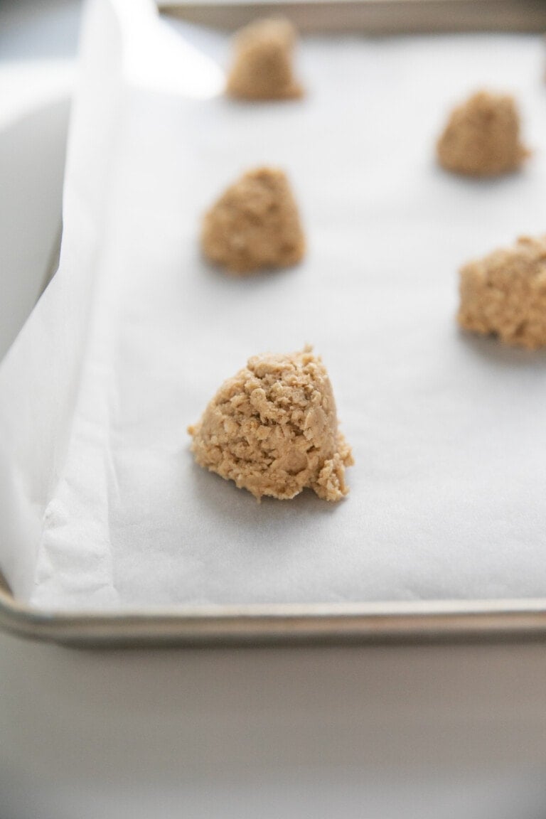 peanut butter oatmeal cookie dough scooped onto baking sheet